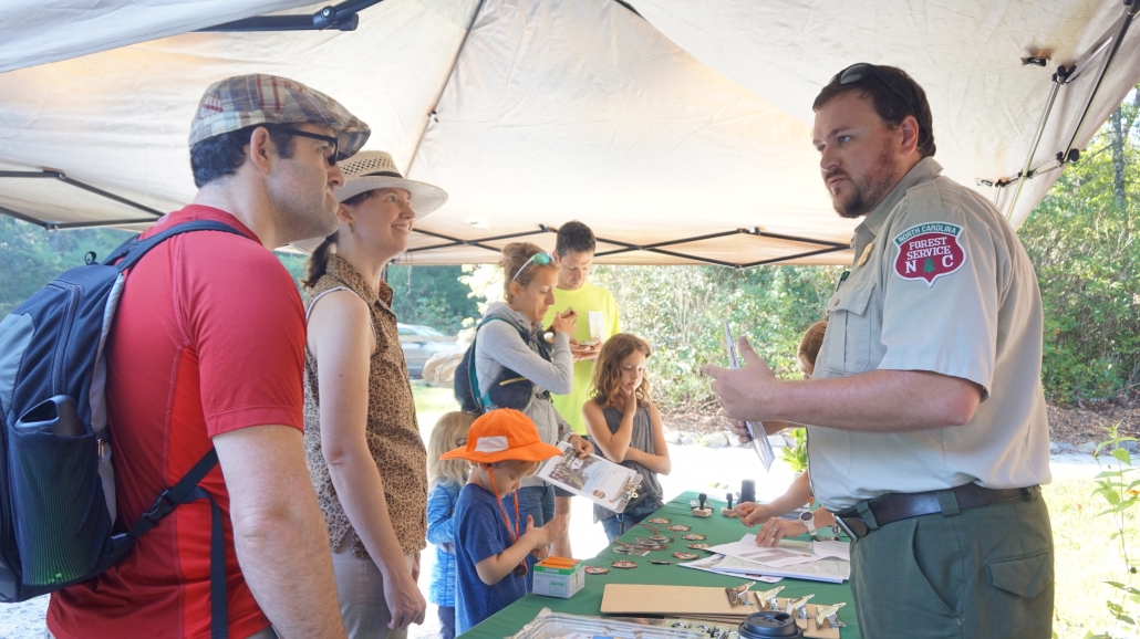 family and park ranger at information tent