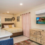 bed and dresser in renovated hotel room