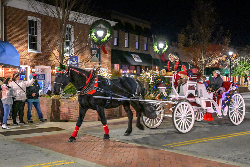 Visitors enjoy a holiday carriage ride on Main Street in Hendersonville, NC