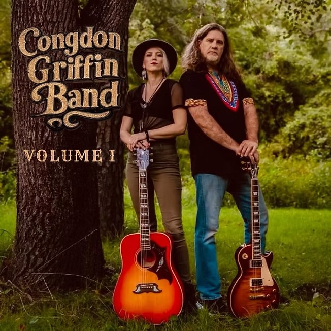 two-people-against-tree-with-guitars