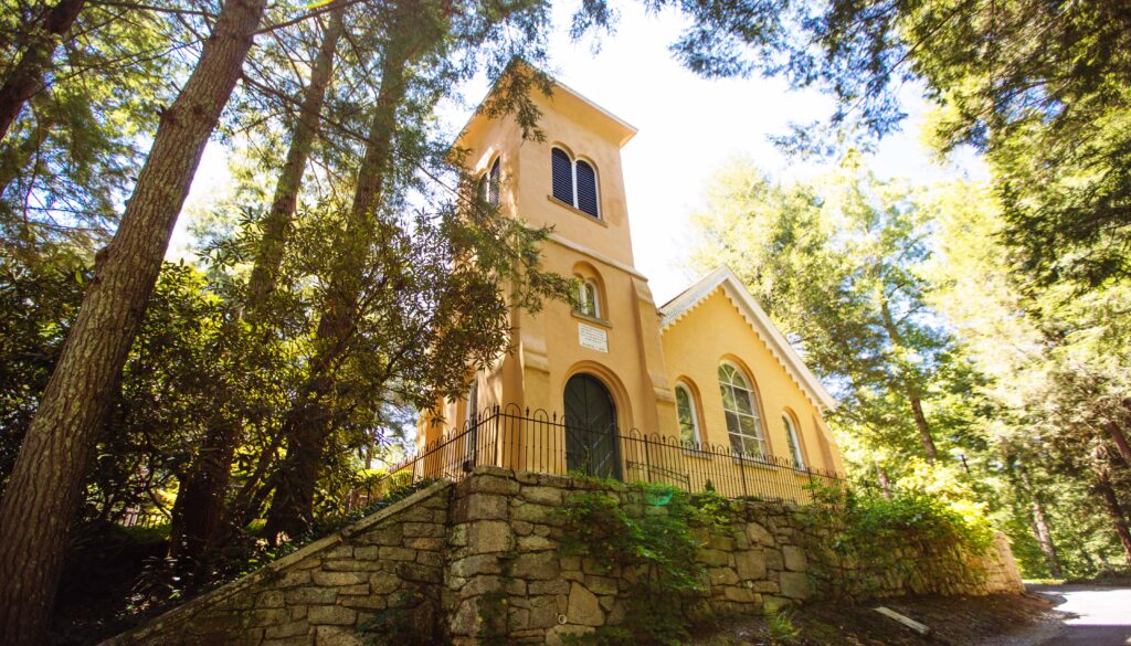 historic yellow church in the woods